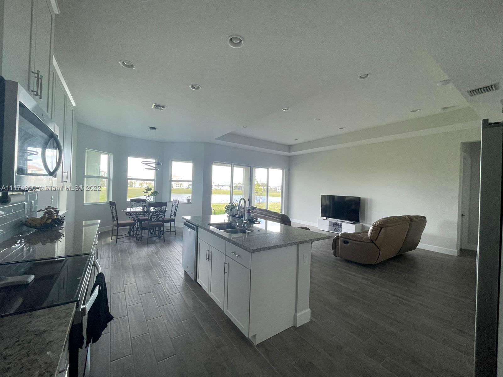 The Acreage Loxahatchee, FL 33470 - Photo 35 of 63 a living room with furniture and wooden floor
