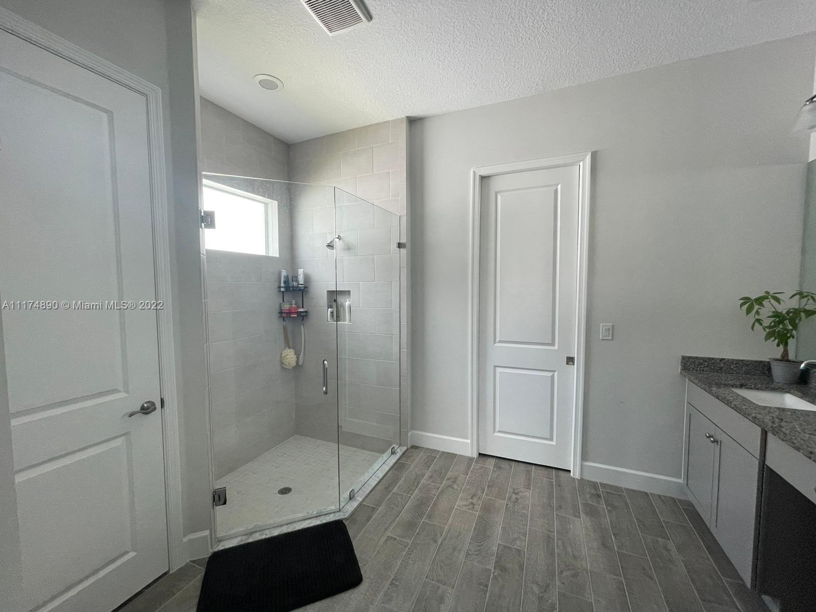 The Acreage Loxahatchee, FL 33470 - Photo 43 of 63 a bathroom with a sink a toilet and shower