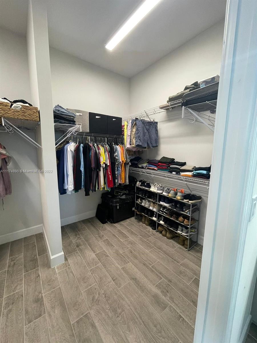 The Acreage Loxahatchee, FL 33470 - Photo 54 of 63 a view of walk in closet with clothes and shoes