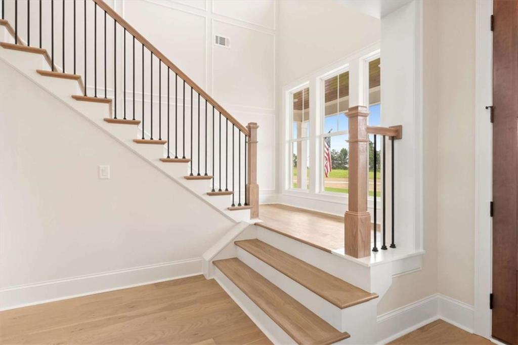 591 Welcome Road Roopville, GA 30170 - Photo 38 of 60 a view of staircase with lots of frames on wall and a window