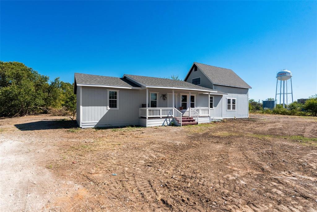 506 North Fm 156 Ponder, TX 76259 - Photo 2 of 23 a front view of a house with yard patio and fire pit