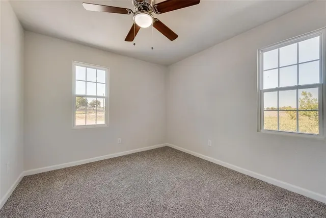 a view of a dining room that has a table and a chair