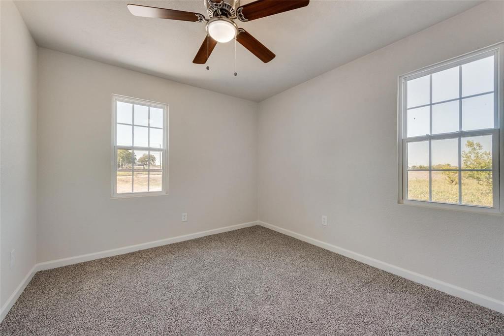 506 North Fm 156 Ponder, TX 76259 - Photo 22 of 23 an empty room with a window and a ceiling fan