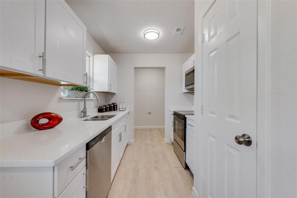 506 North Fm 156 Ponder, TX 76259 - Photo 8 of 23 a kitchen with a sink a stove and cabinets