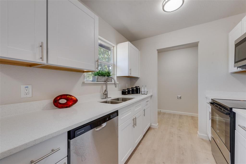 506 North Fm 156 Ponder, TX 76259 - Photo 9 of 23 a kitchen with stainless steel appliances a sink stove and cabinets