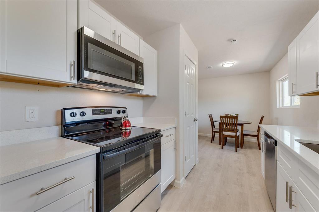 506 North Fm 156 Ponder, TX 76259 - Photo 10 of 23 a kitchen with stainless steel appliances a stove microwave and cabinets