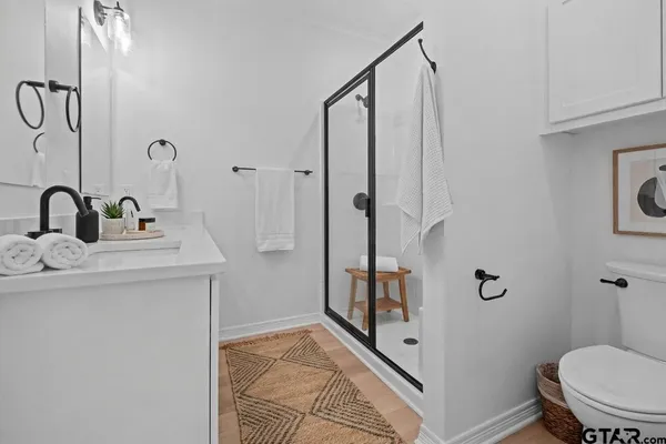 a bathroom with a sink toilet and shower