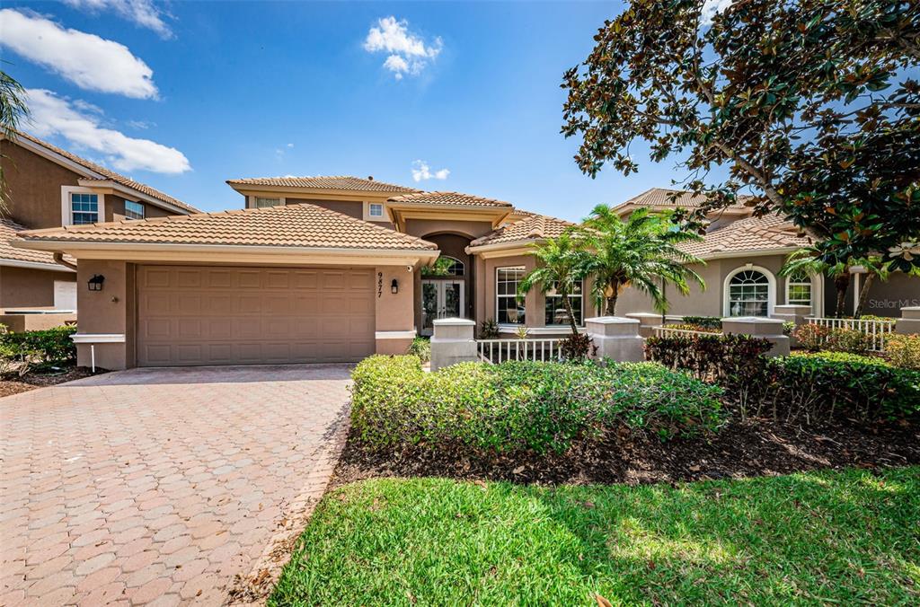 9877 Sago Point Drive Seminole, FL 33777 - Photo 1 of 31 a front view of a house with a garden