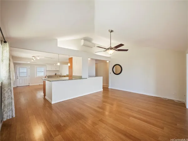 a view of a kitchen with a sink wooden floor and a window