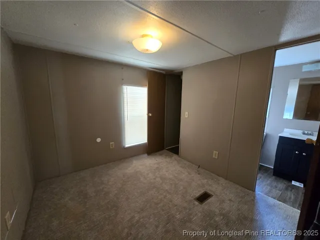 an empty room with windows and closet