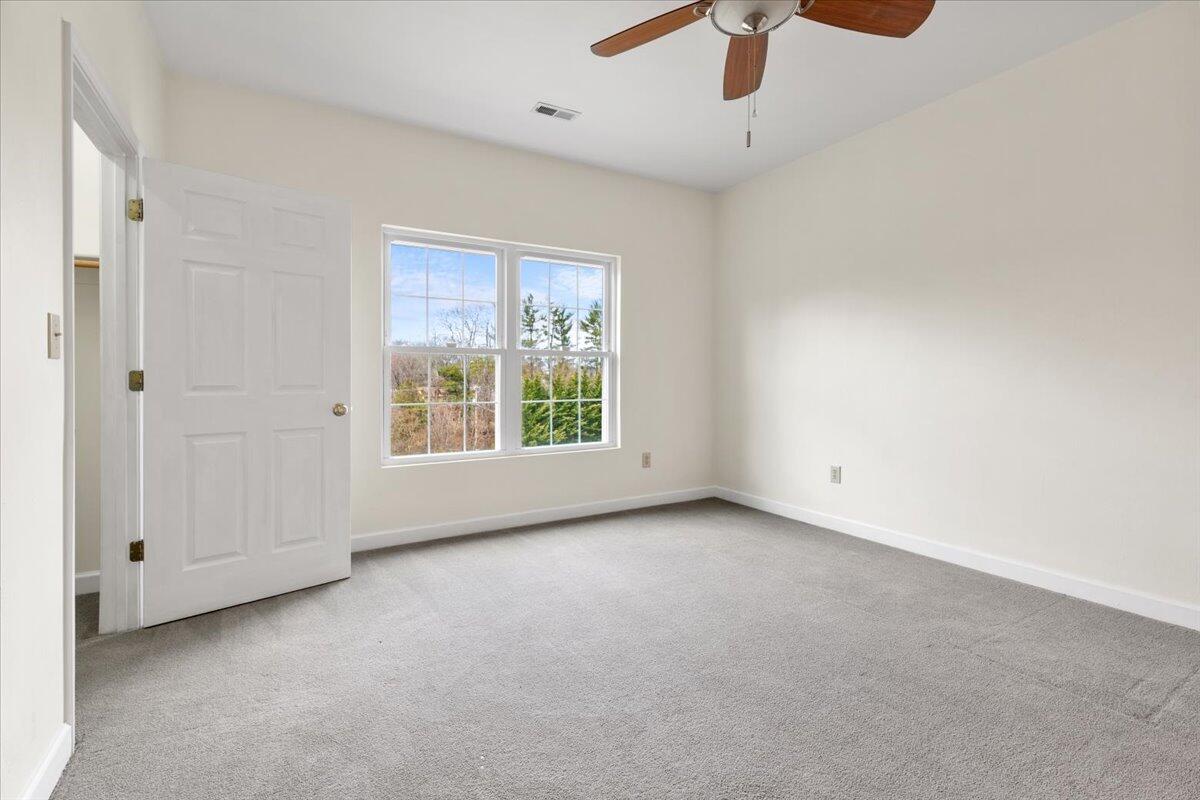 3409 Laurel Circle Roanoke, VA 24018 - Photo 22 of 34 an empty room with chandelier fan and windows