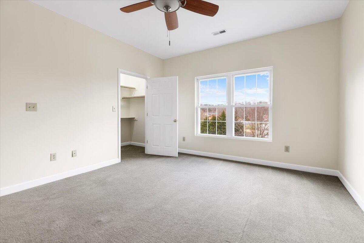 3409 Laurel Circle Roanoke, VA 24018 - Photo 23 of 34 an empty room with chandelier fan and windows