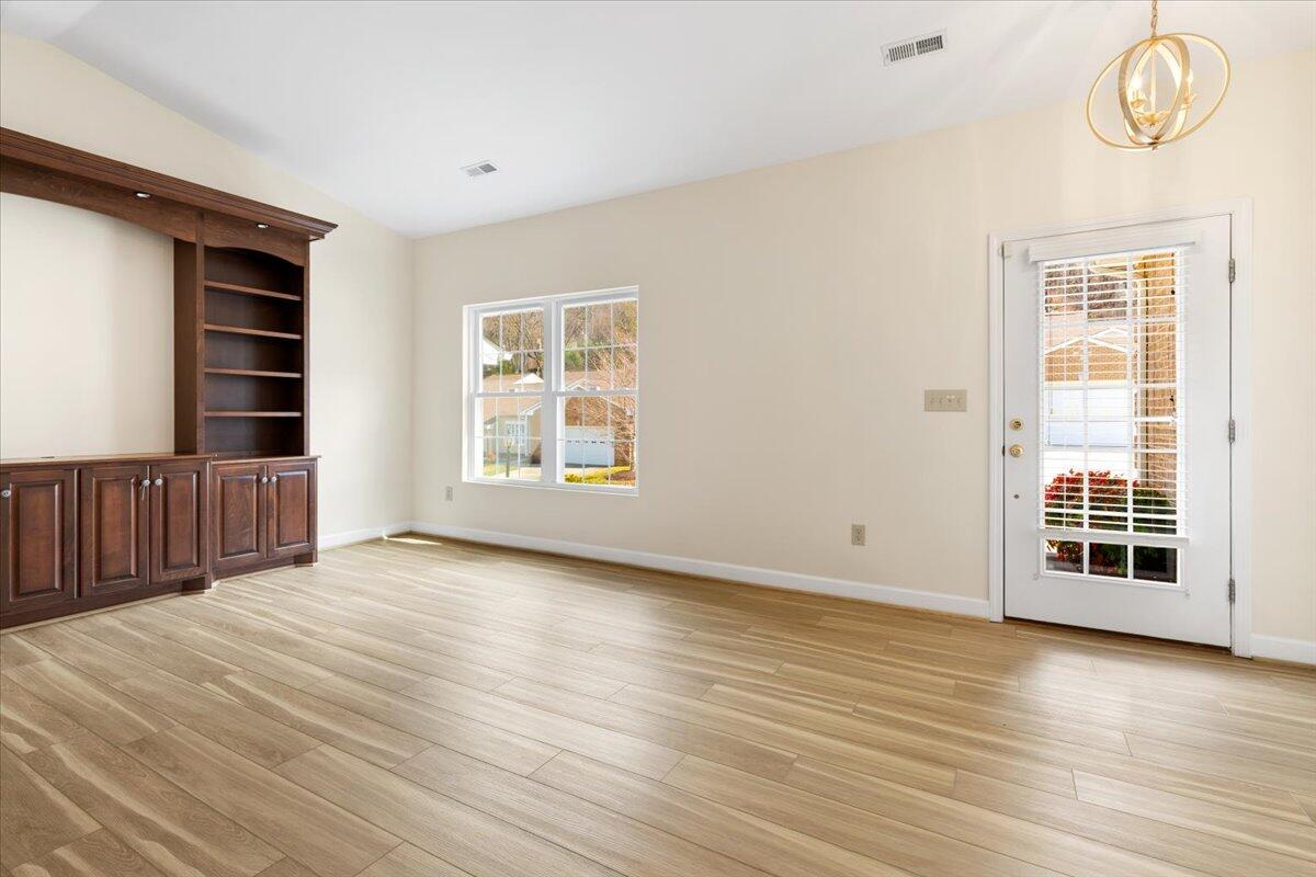 3409 Laurel Circle Roanoke, VA 24018 - Photo 5 of 34 an empty room with wooden floor and windows