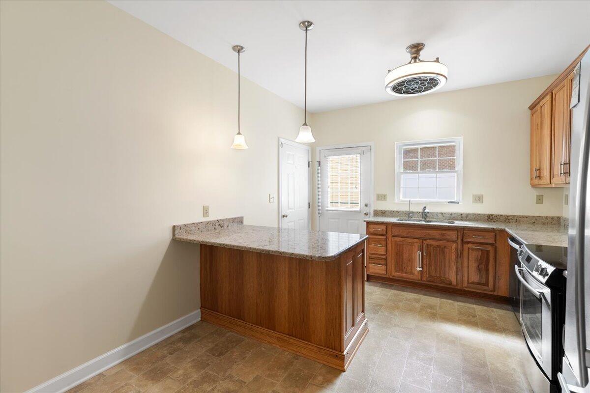 3409 Laurel Circle Roanoke, VA 24018 - Photo 9 of 34 a kitchen with kitchen island a sink a stove a counter space and a window