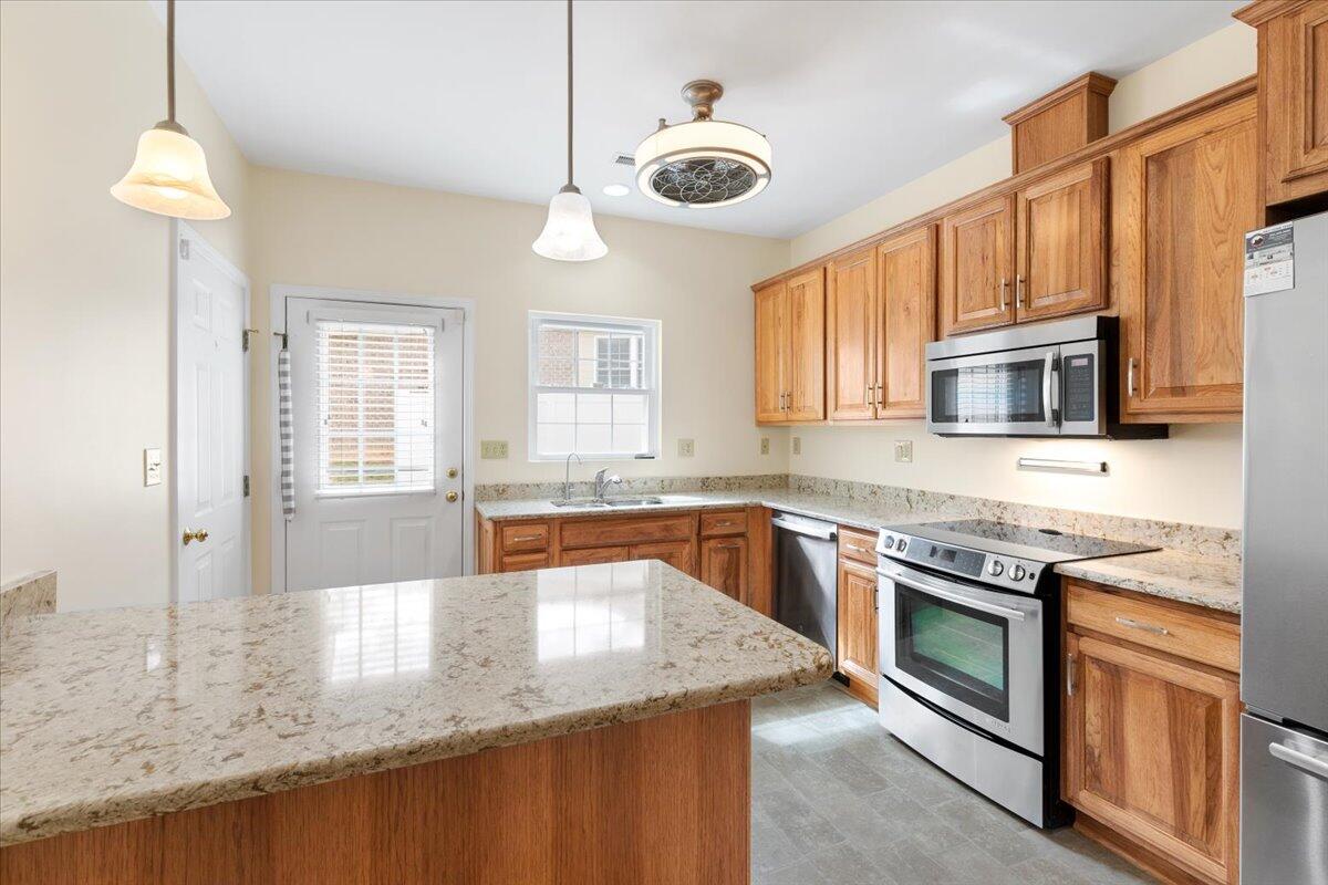 3409 Laurel Circle Roanoke, VA 24018 - Photo 10 of 34 a kitchen with stainless steel appliances granite countertop a stove top oven a sink a dining table and chairs with wooden floor