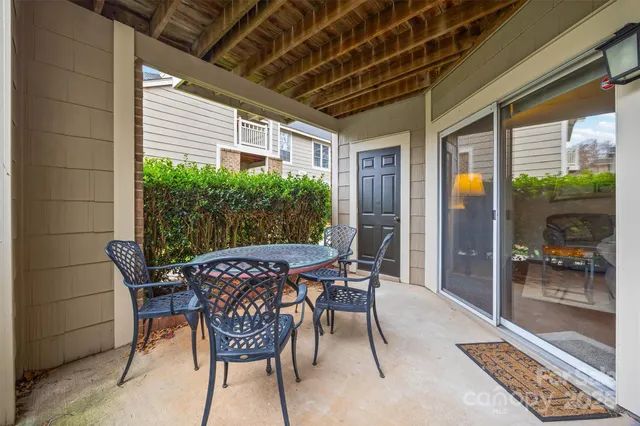 a view of a patio with table and chairs and potted plants