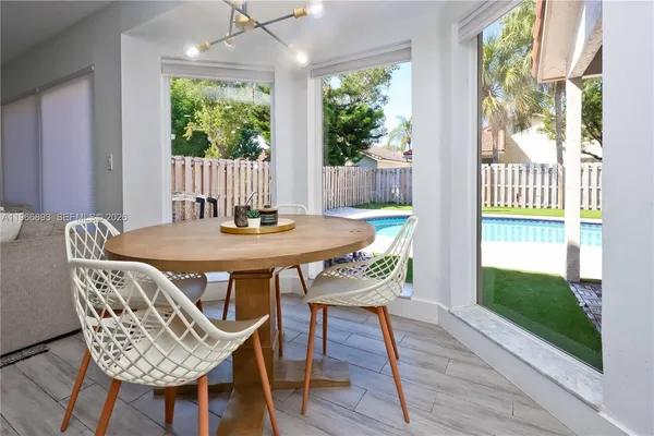 a dining room with furniture a rug and wooden floor