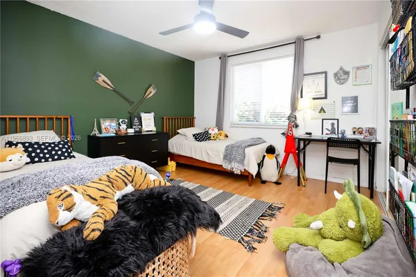 a bed room with two bed and a chair