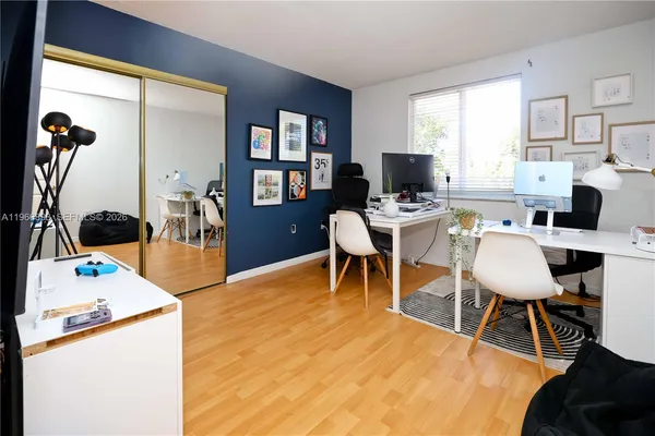 a workspace with furniture and a wooden floor