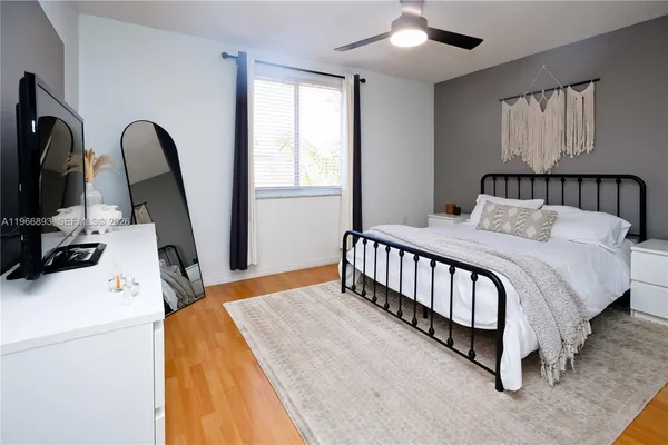 a bed room with a bed and a television