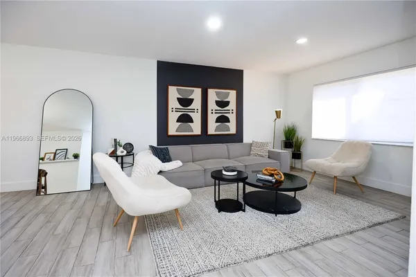 a living room with furniture and wooden floor