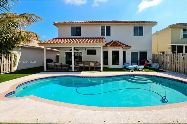 a view of a house with swimming pool and porch