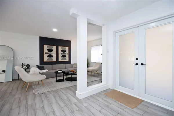 a living room with furniture and a wooden floor