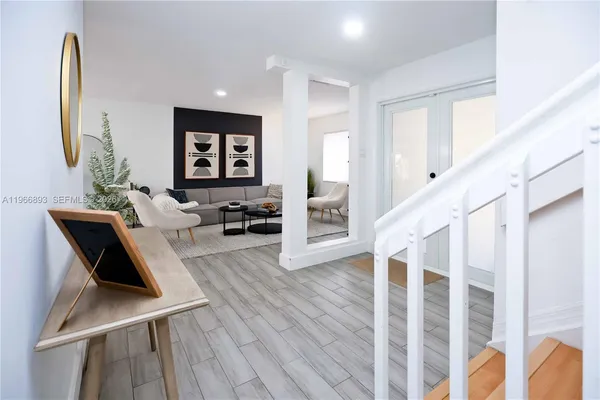 a view of living room with furniture and wooden floor