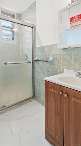 a bathroom with a shower and a sink