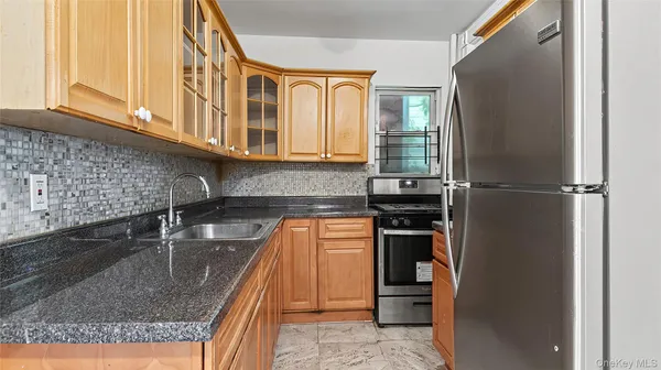 a kitchen with a refrigerator and a sink