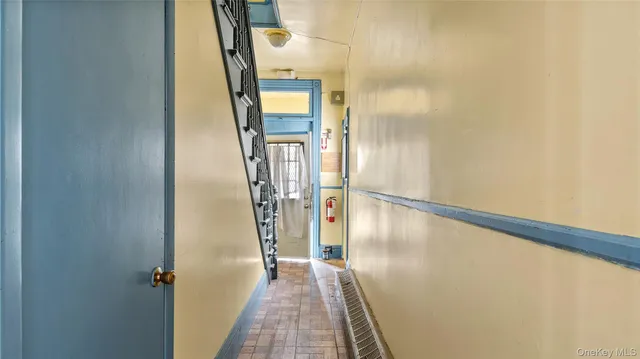 a view of a hallway with wooden floor and entryway