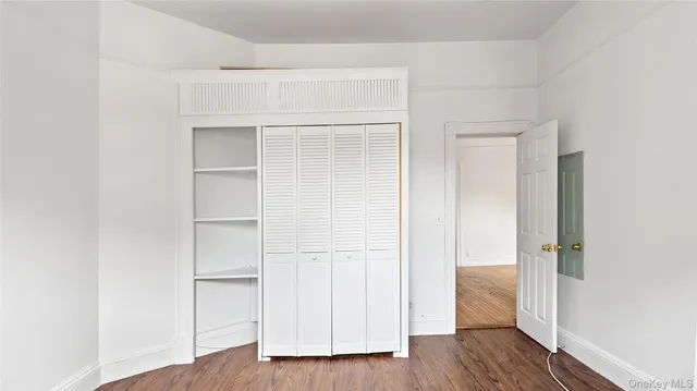 a view of walk in closet with wooden floor