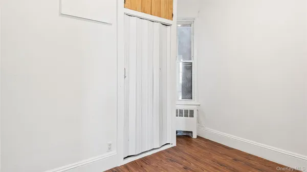a view of an entryway with wooden floor
