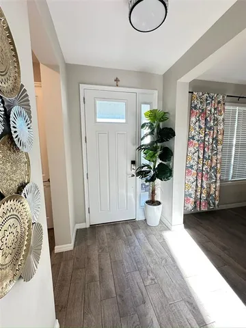 a living room with furniture window and a wooden floor