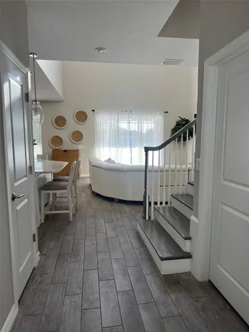 a view of an empty room with wooden floor