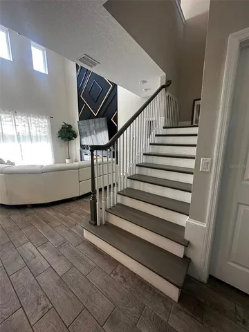 a view of a hallway view with wooden floor and staircase