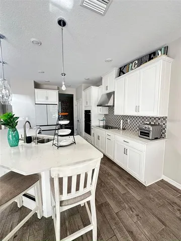 a living room with hard wood floors and a wooden floors