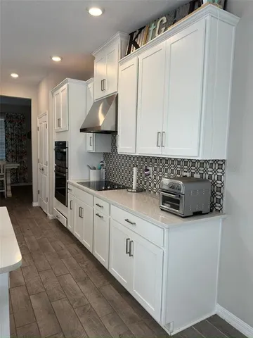 a view of a patio with chairs and umbrellas