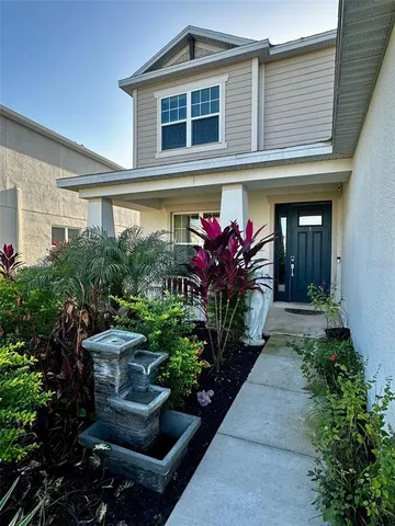 a front view of a house with plants