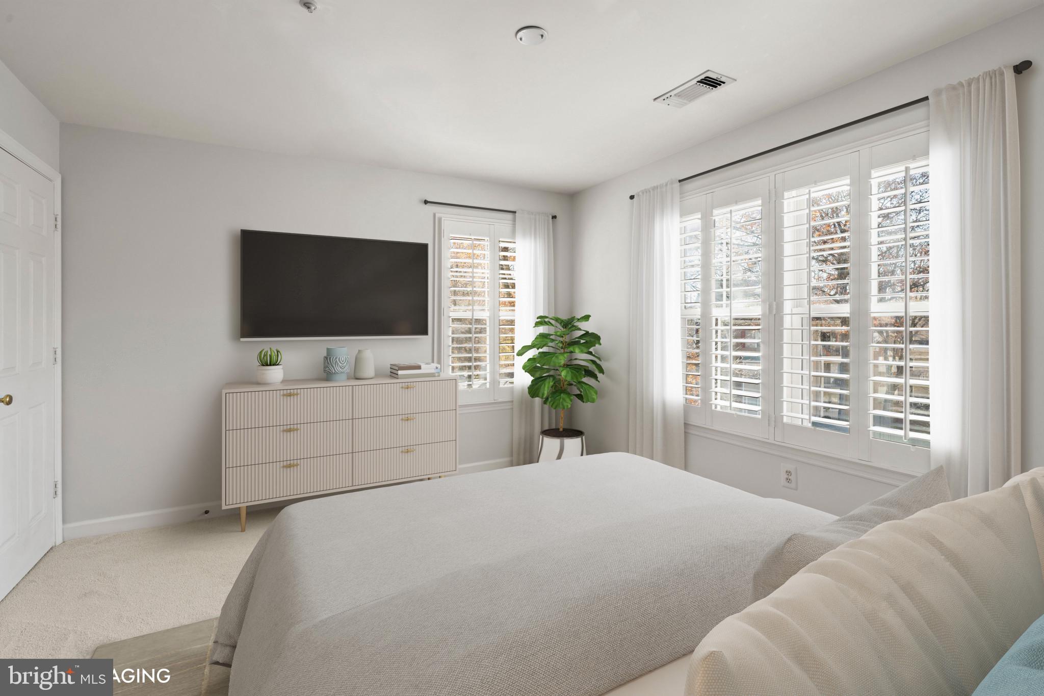 6832 Hayley Ridge Way, Unit D Baltimore, MD 21209 - Photo 13 of 33 a bedroom with a large tv and bed