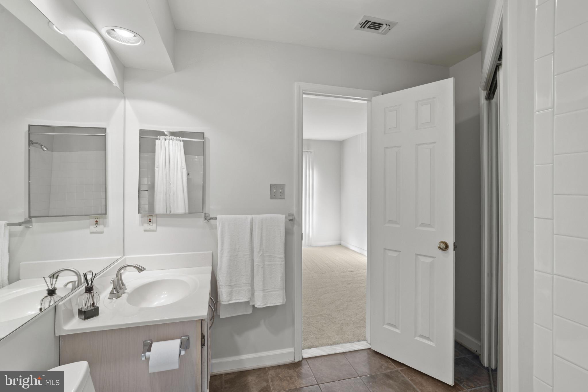 6832 Hayley Ridge Way, Unit D Baltimore, MD 21209 - Photo 22 of 33 a bathroom with a sink and a mirror