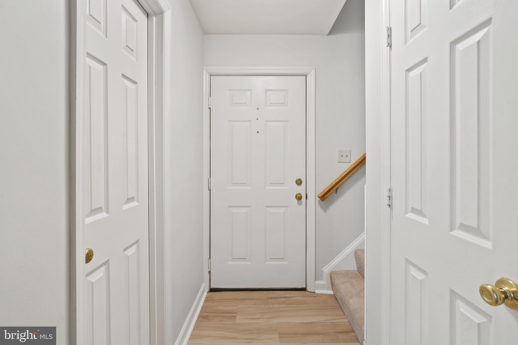 6832 Hayley Ridge Way, Unit D Baltimore, MD 21209 - Photo 28 of 33 a view of a hallway with a wooden door and staircase
