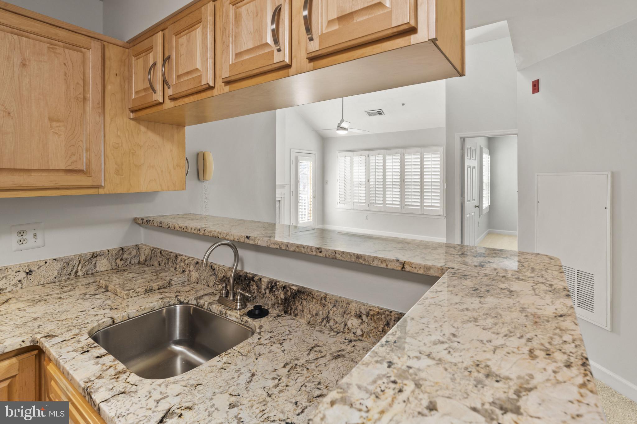 6832 Hayley Ridge Way, Unit D Baltimore, MD 21209 - Photo 7 of 33 a kitchen with a sink and cabinets