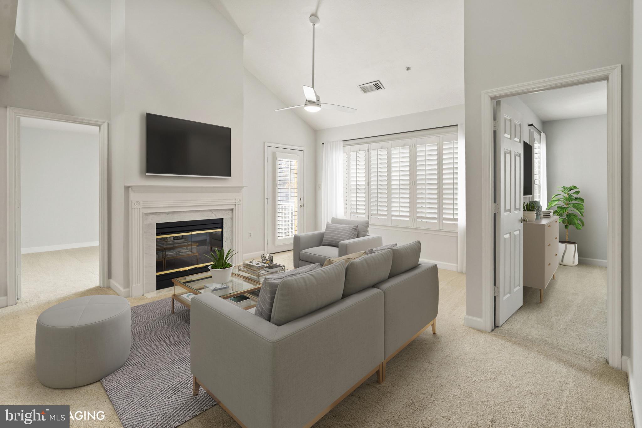 6832 Hayley Ridge Way, Unit D Baltimore, MD 21209 - Photo 8 of 33 a living room with furniture a flat screen tv and a fireplace