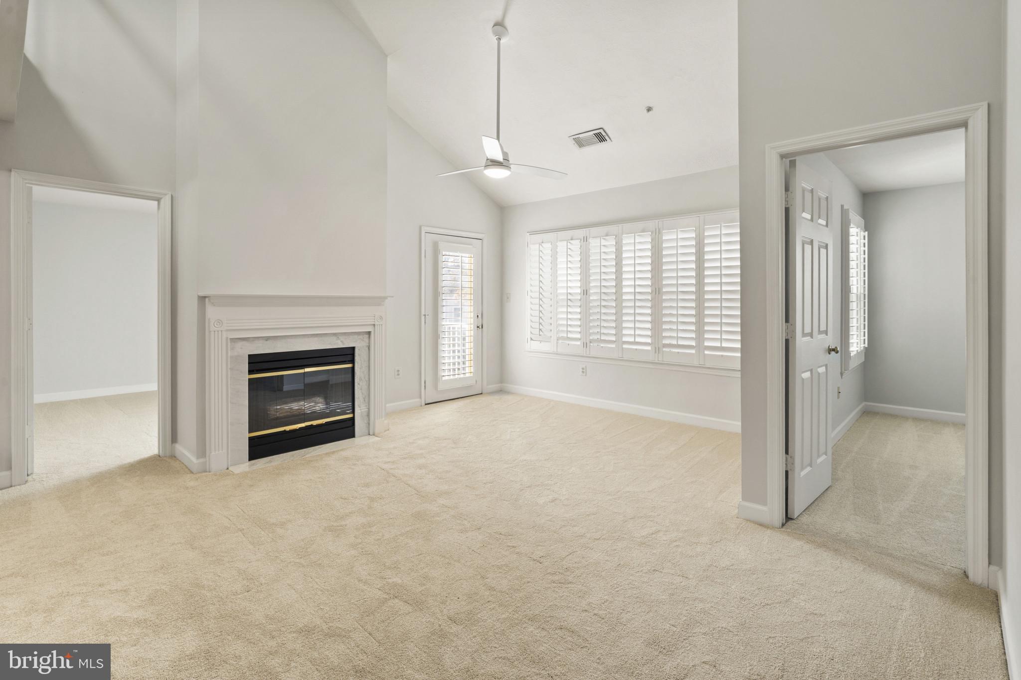6832 Hayley Ridge Way, Unit D Baltimore, MD 21209 - Photo 9 of 33 a view of an empty room with a fireplace and a window