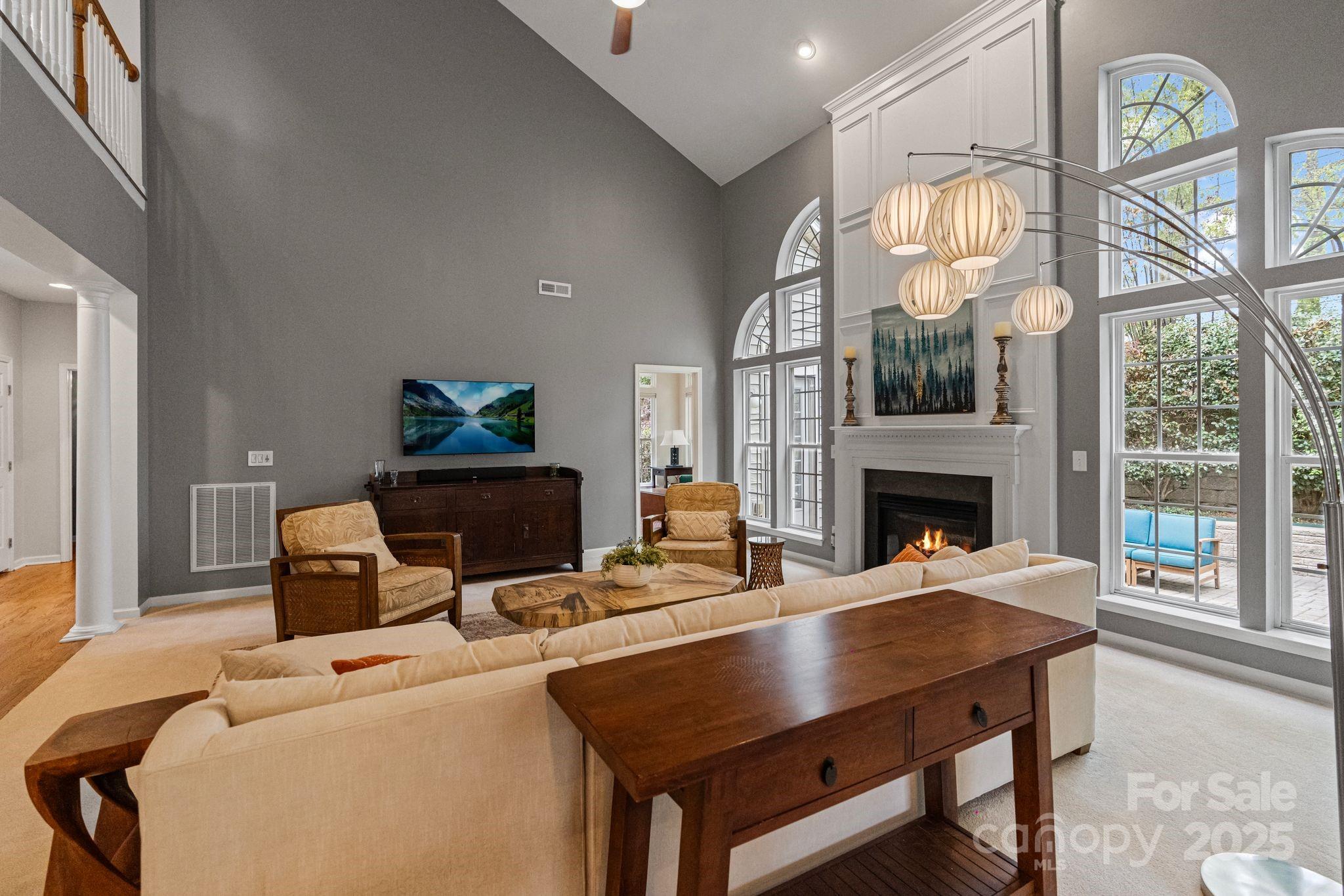 1039 Sharon Lee Avenue Fort Mill, SC 29708 - Photo 15 of 46 a living room with furniture a fireplace and a floor to ceiling window