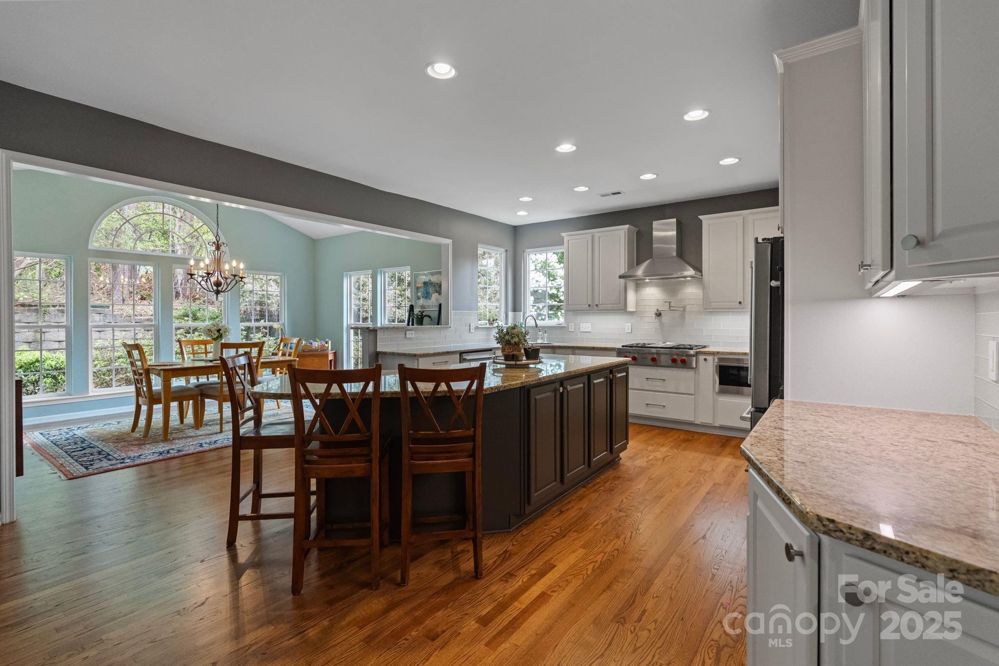 1039 Sharon Lee Avenue Fort Mill, SC 29708 - Photo 16 of 46 a large kitchen with lots of furniture a sink appliances and dining table