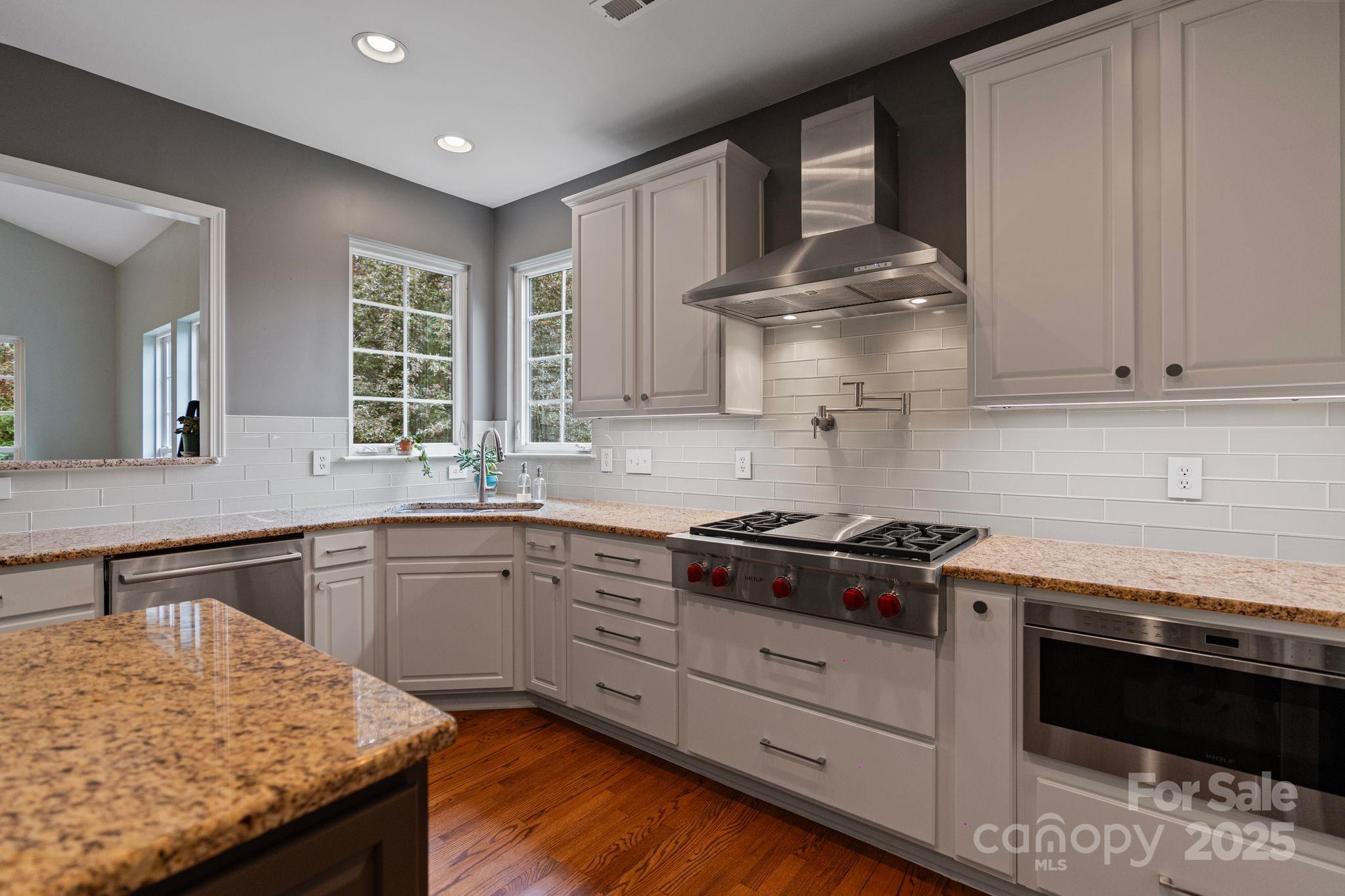1039 Sharon Lee Avenue Fort Mill, SC 29708 - Photo 18 of 46 a kitchen with granite countertop wooden cabinets and a stove top oven