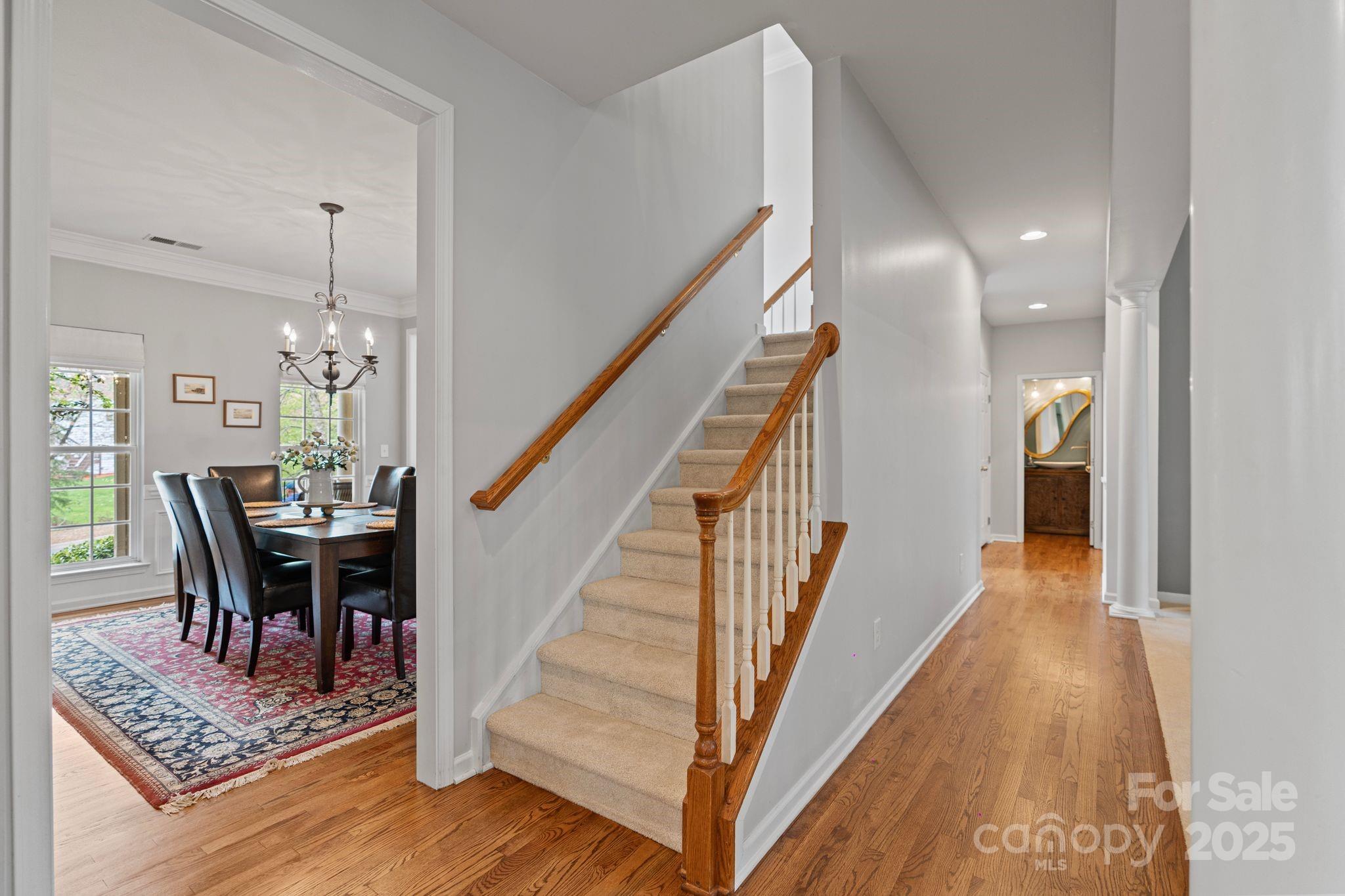 1039 Sharon Lee Avenue Fort Mill, SC 29708 - Photo 22 of 46 a view of a hallway with wooden floor and stairs