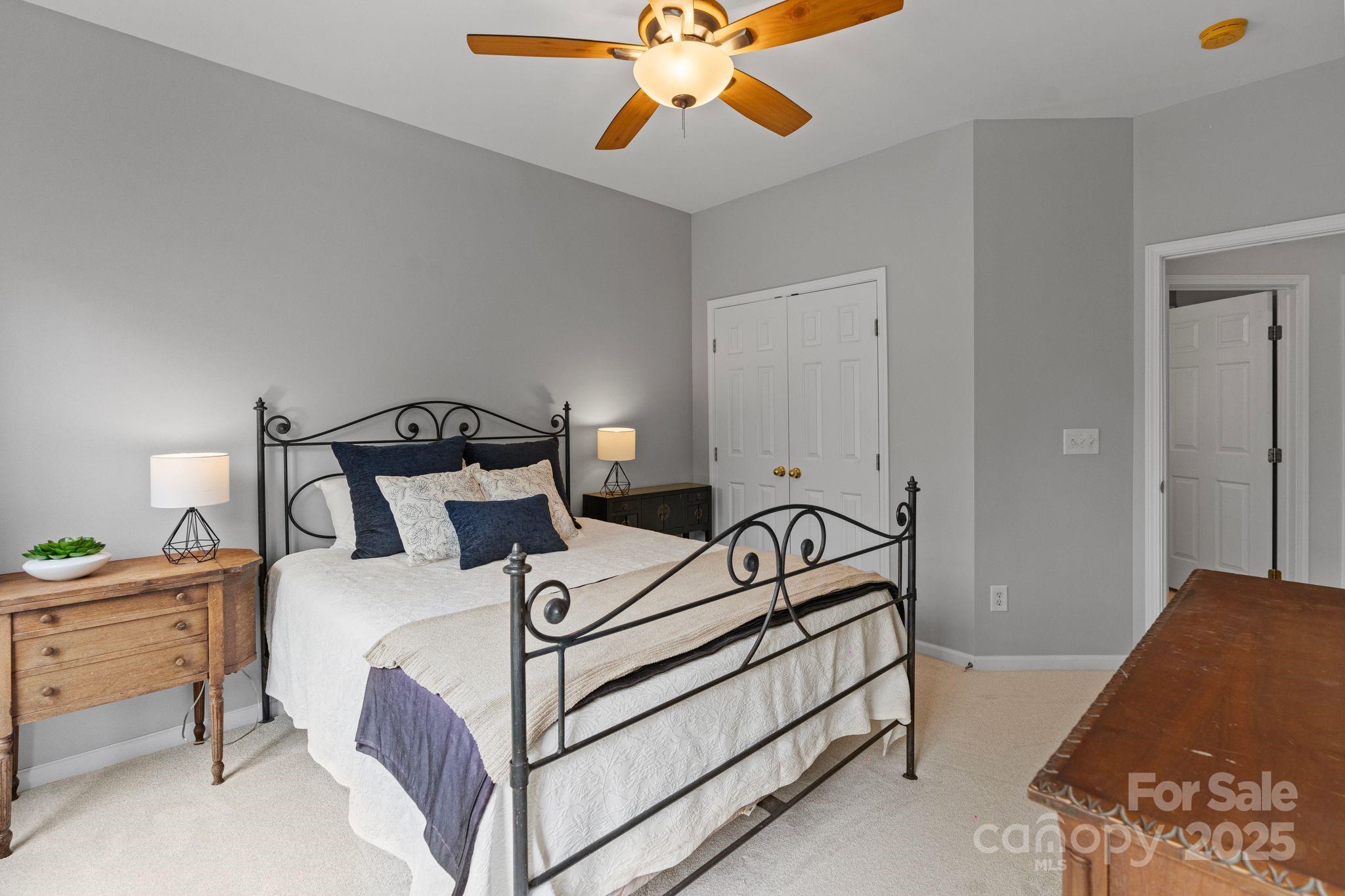 1039 Sharon Lee Avenue Fort Mill, SC 29708 - Photo 26 of 46 a bedroom with a bed and a chandelier